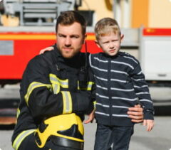 Firefighter smiles with a child