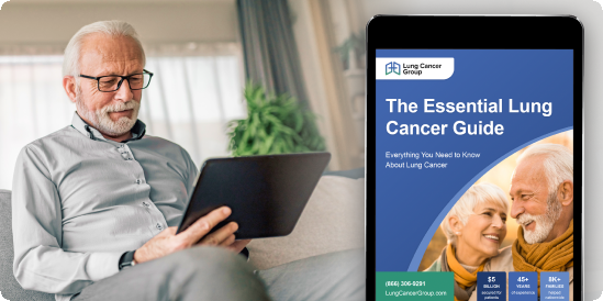 A man sits holding a tablet with a closeup of the Essential Lung Cancer Guide shown on the tablet